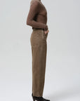 Miro Full Length Deck Pant by Citizens Of Humanity/AGOLDE in profile, paired with a brown sweater and black boots.