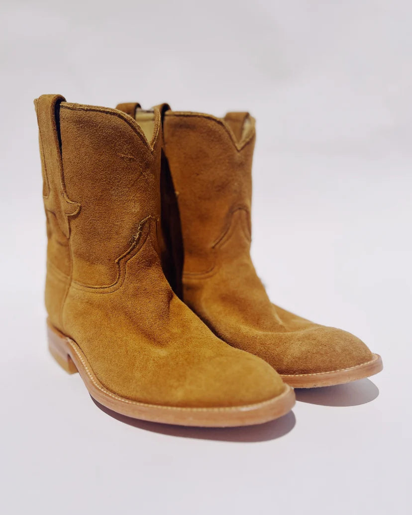 A pair of Hey Gang's The Ranch Boot in light brown calf skin suede, with a smooth sole, stands side by side against a plain white background.