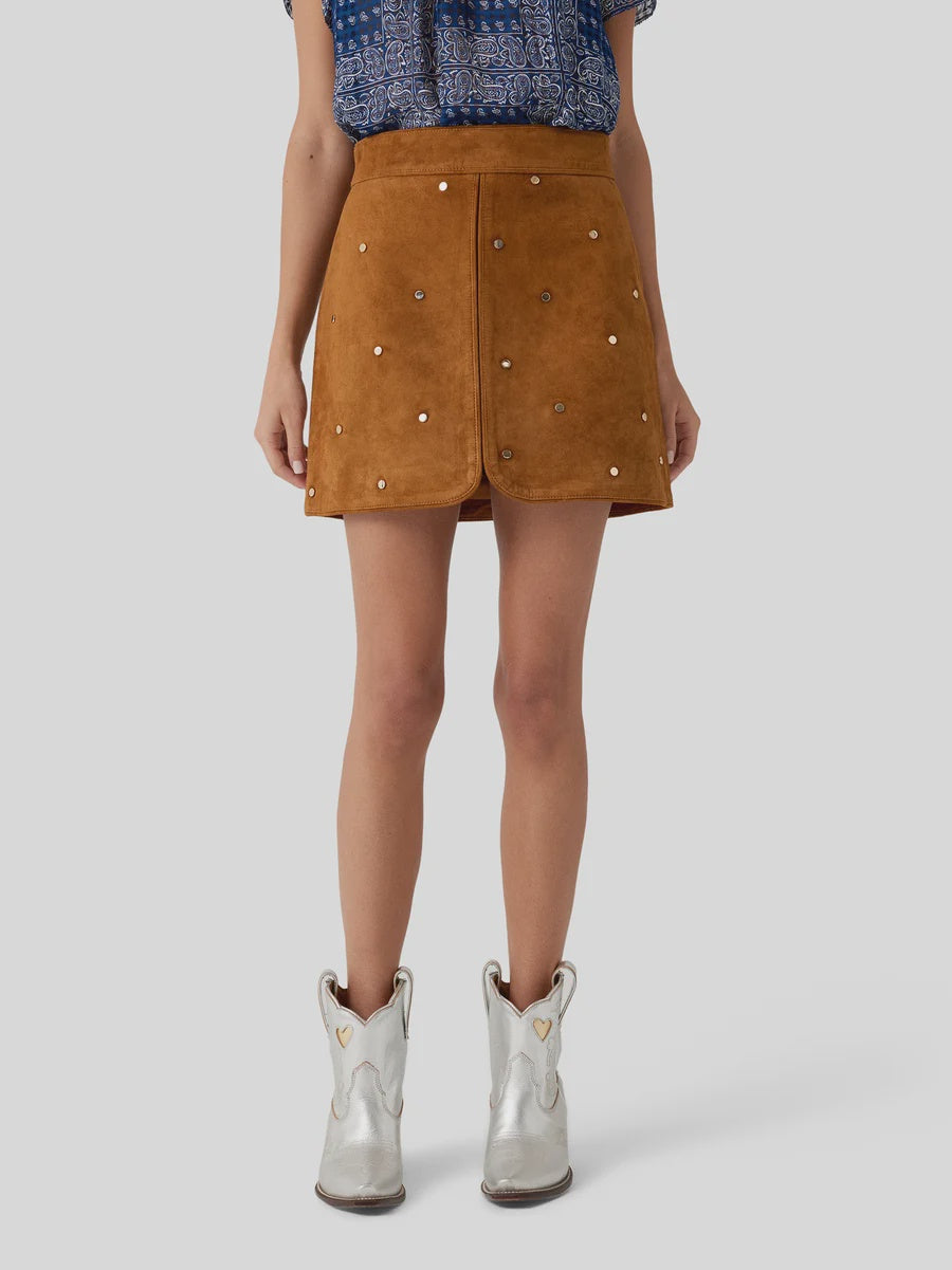 Hunter Bell NYC Dottie Skirt with a blue patterned top and silver boots, modern style against gray backdrop.