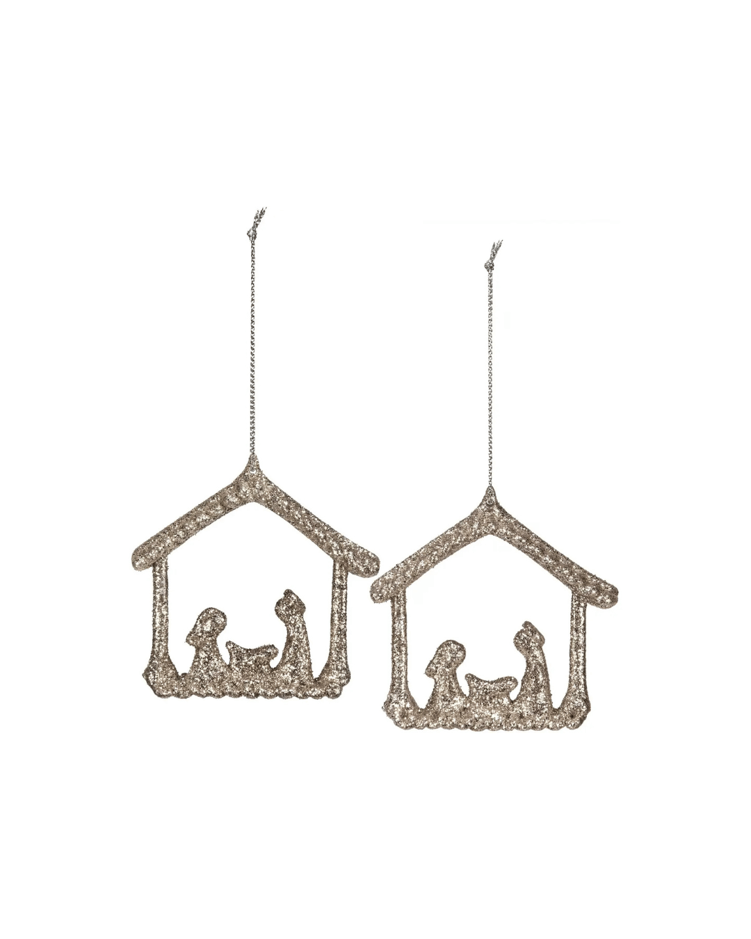 Faire's Nativity ornaments showcase minimalist, cut-out designs of stable structures and figures, elegantly adorned with champagne-colored glitter. These silver Christmas decorations are suspended by delicate string loops, allowing them to shimmer beautifully in the light.