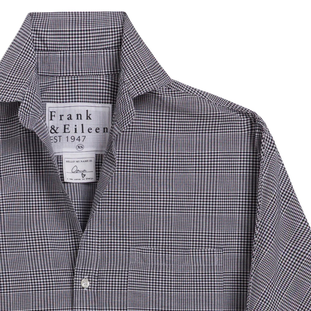 A close-up of the Frank & Eileen Oona Continuous Button-Up Shirt, featuring a black-and-white checkered pattern, collar, and continuous sleeves. The relaxed-fit shirt displays only the upper portion and left sleeve in the image.