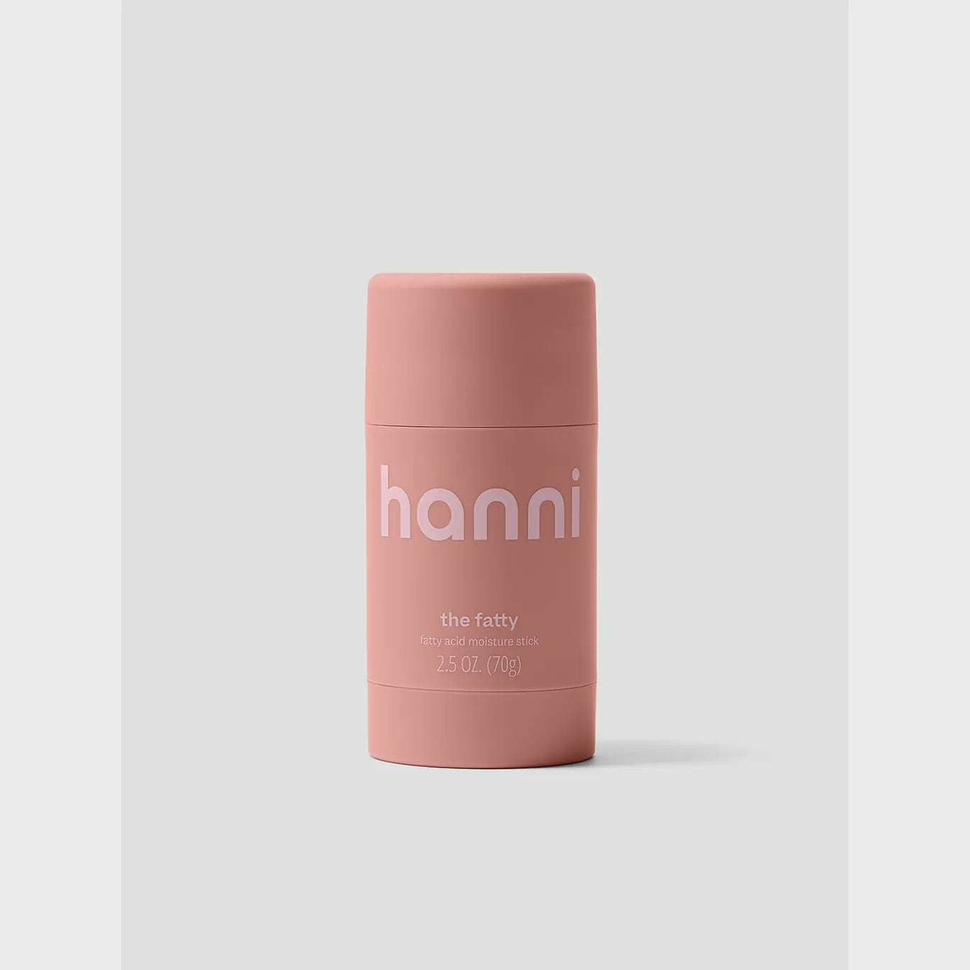 Against a light gray background is a pink cylindrical container labeled "Hanni The Fatty" by Faire, shave and moisture stick, 2.5 oz (70g). It's perfect for sensitive skin, enriched with Omega 3 and 6 fatty acids to enhance skin repair.