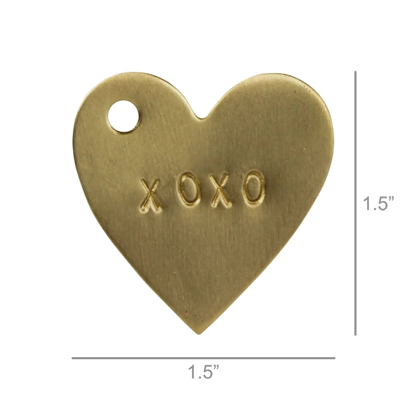 The HomArt Brass Tag XOXO is a 1.5-inch heart-shaped brass charm with "XOXO" engraved at the center and a hole near the top left, ideal as a unique gift tag for special occasions.
