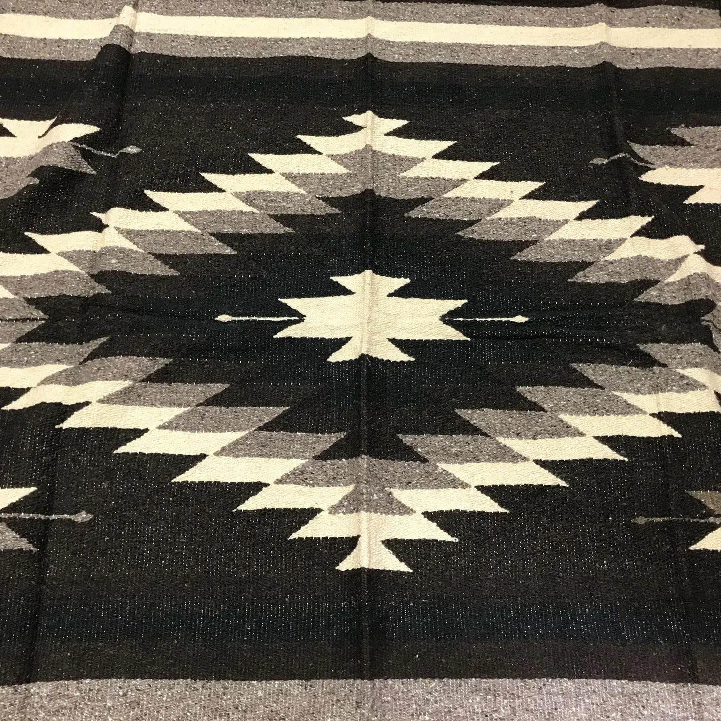 The Faire XL Mexican Diamond Blanket in Brown & Black features a bold, geometric zigzag diamond pattern inspired by Southwestern designs—ideal as a yoga blanket or to add style and warmth as a heavyweight Baja throw.