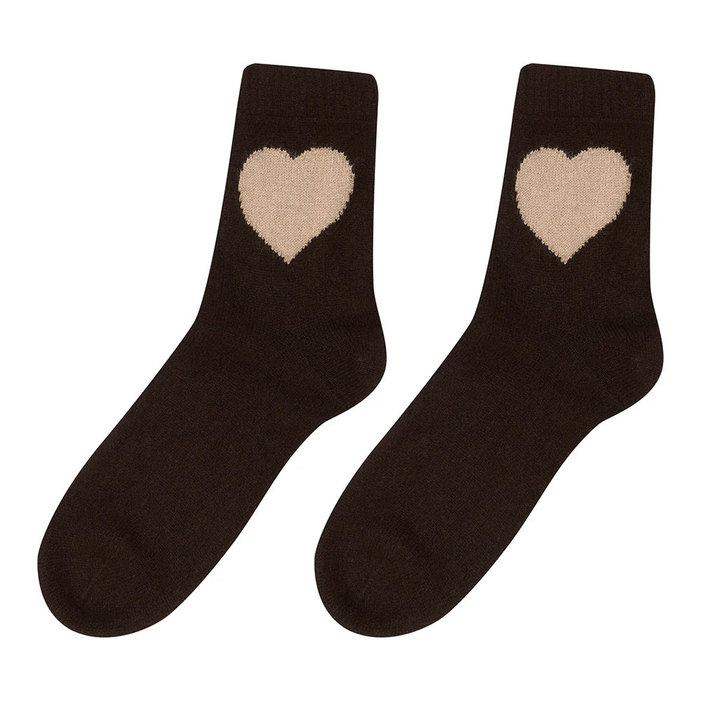 A pair of Heart Socks by Jumper 1 2 3 4/CR2: black socks featuring a large beige heart design near the top of each sock.