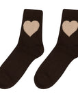 A pair of Heart Socks by Jumper 1 2 3 4/CR2: black socks featuring a large beige heart design near the top of each sock.