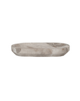 The Creative Co-op Marble Dish is an oval, buff-colored tray with tapered edges and a polished surface. It measures 9-3/4"L x 5"W and exudes minimalist elegance.