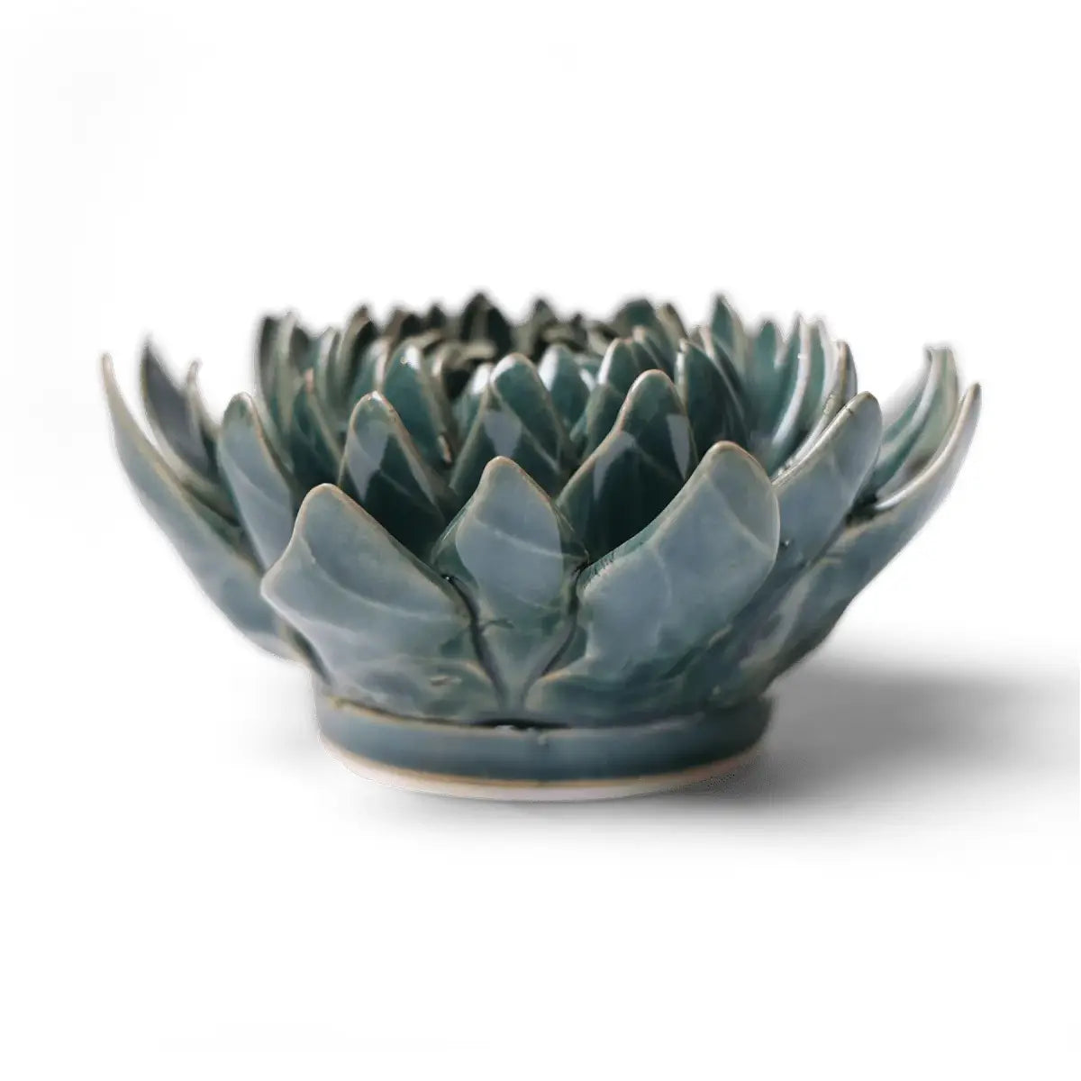 The Dahlia Teal by Chive Ceramics (thru Faire) is a handmade ceramic bowl with glossy blue-green, dahlia-shaped petals, ideal for lovers of unique pottery and ceramic flowers, shown on a plain white background.