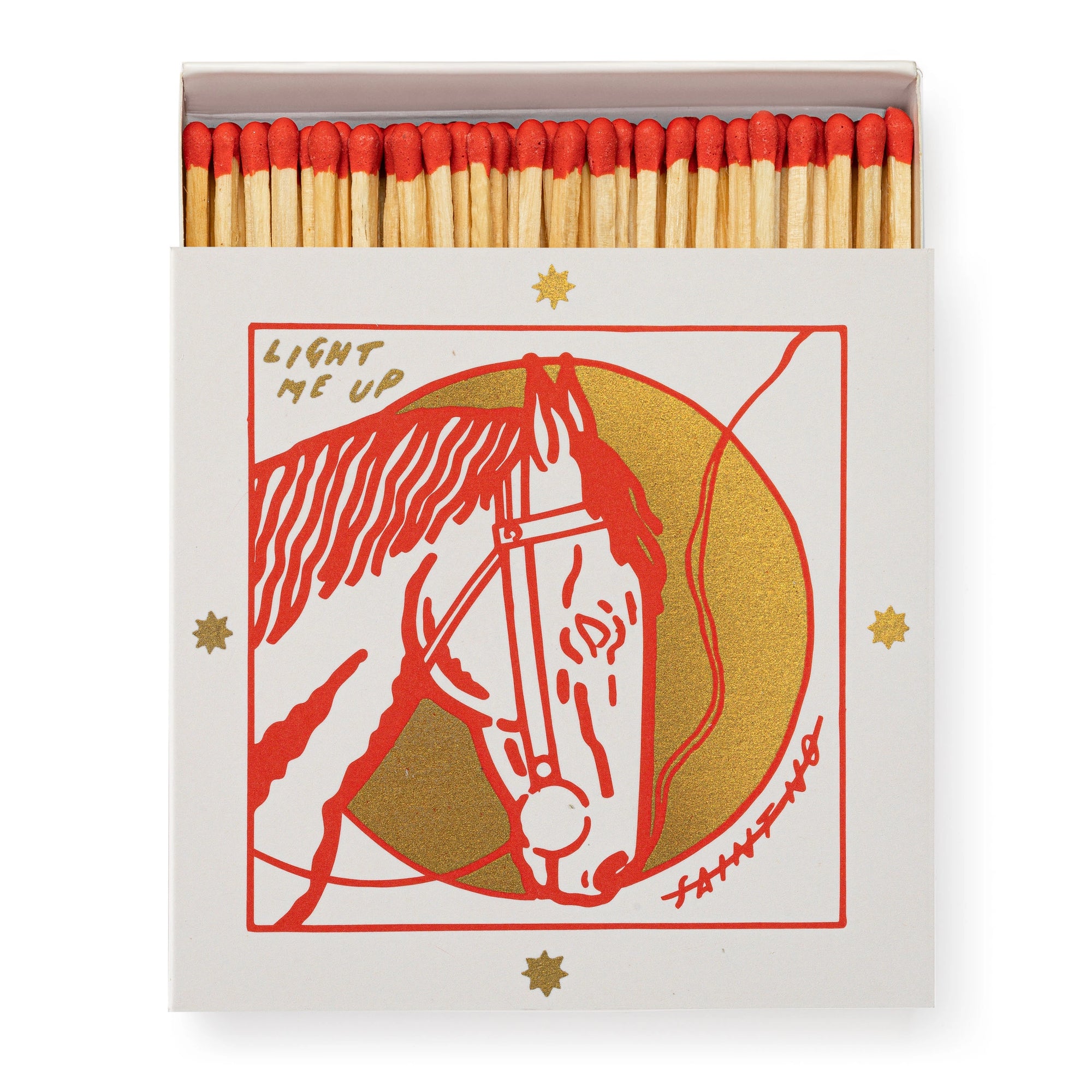A box of Matches/Square by Faire features red-tipped matches and a cover with a red and gold illustrated horse head, encircled by gold stars, and the words "LIGHT ME UP" above the design.