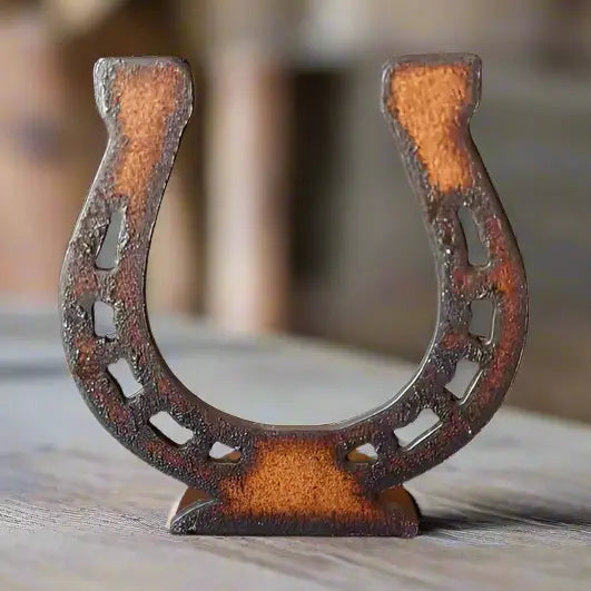 The Faire Horseshoe Rustic Western Doodad features a weathered, upright horseshoe design on wood, ideal as rustic decor for any western-themed space.