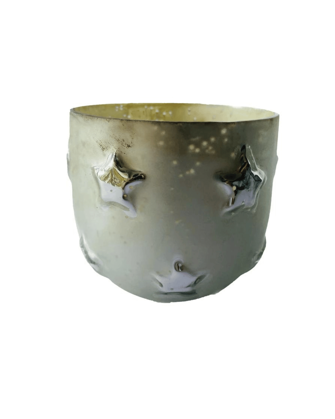 The Creative Co-op Glass Tealight Holder is a translucent white, embossed glass holder featuring star designs and an antique silver finish. It has a slightly frosted surface texture and forms a curved, cylindrical shape. The interior's light sheen enhances its reflective quality.