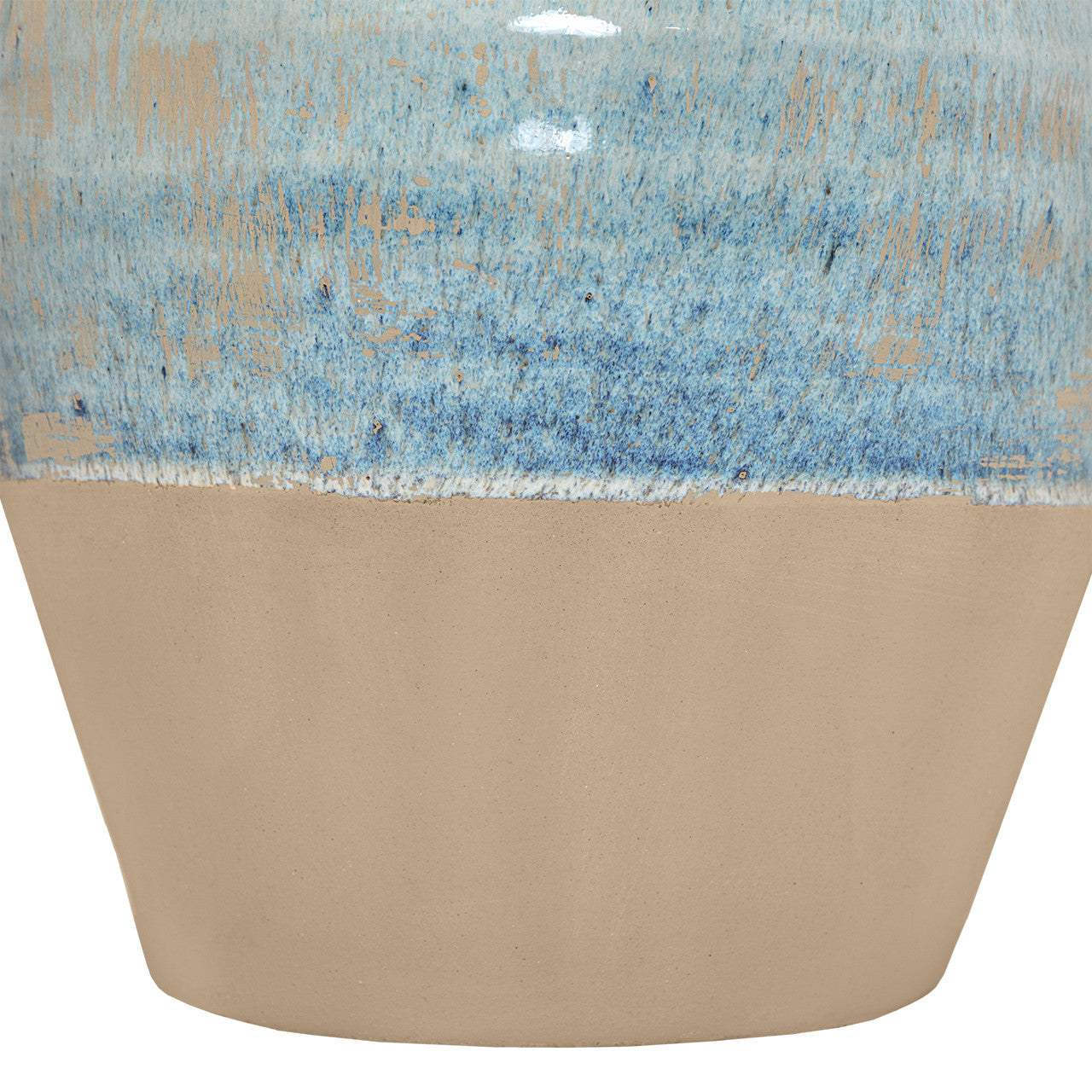 Close-up of the Moroson Vase by The Import Collection, a decorative ceramic vase with a matte tan base and glossy, textured blue upper section displaying speckled, uneven color blending.