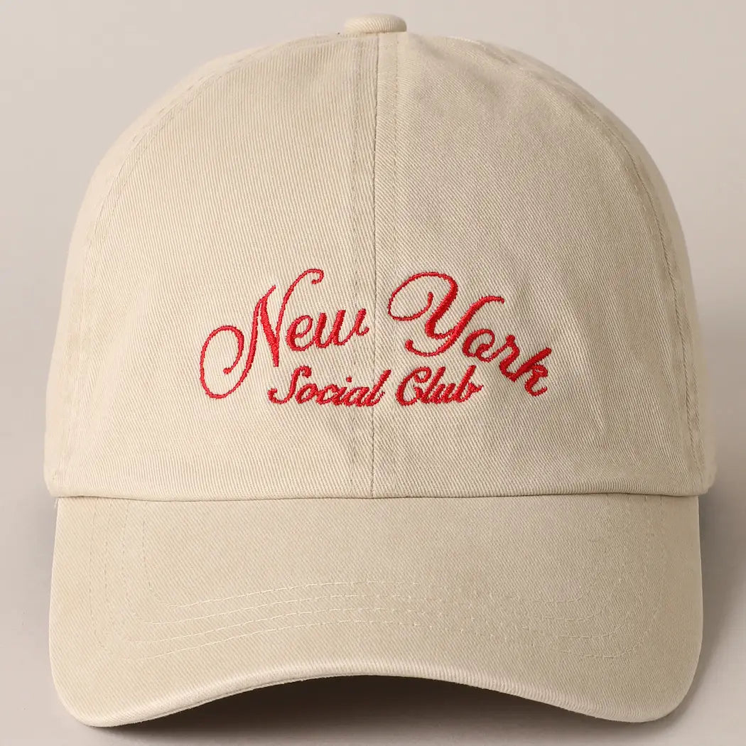 This beige cap from Faire features bold red "New York Social Club" text embroidery on the front and comes with an adjustable strap for a perfect fit.