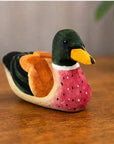 Hand-painted green basswood duck by Faire adds rustic charm and color to table or home decor.