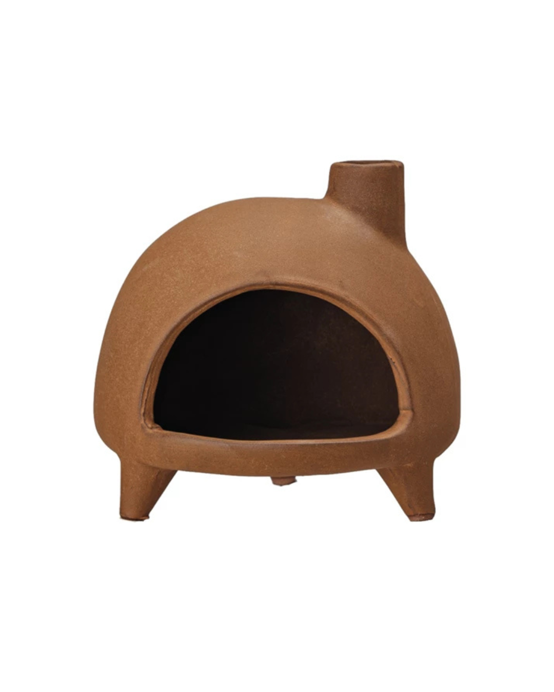 A terra-cotta-colored clay outdoor pizza oven features a domed shape with an open front and rests on three short legs for stability. It is topped with Creative Co-op's Footed Incense Chimney on the top right.