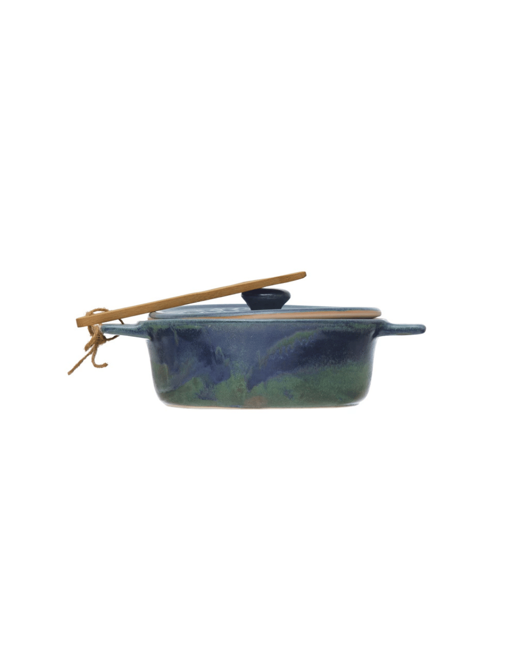 Creative Co-op's Stoneware Brie Baker with Bamboo Spreader features a blue and green glaze, lid, and string-tied bamboo-style spoon resting on top. It includes small handles on each side for easy handling.