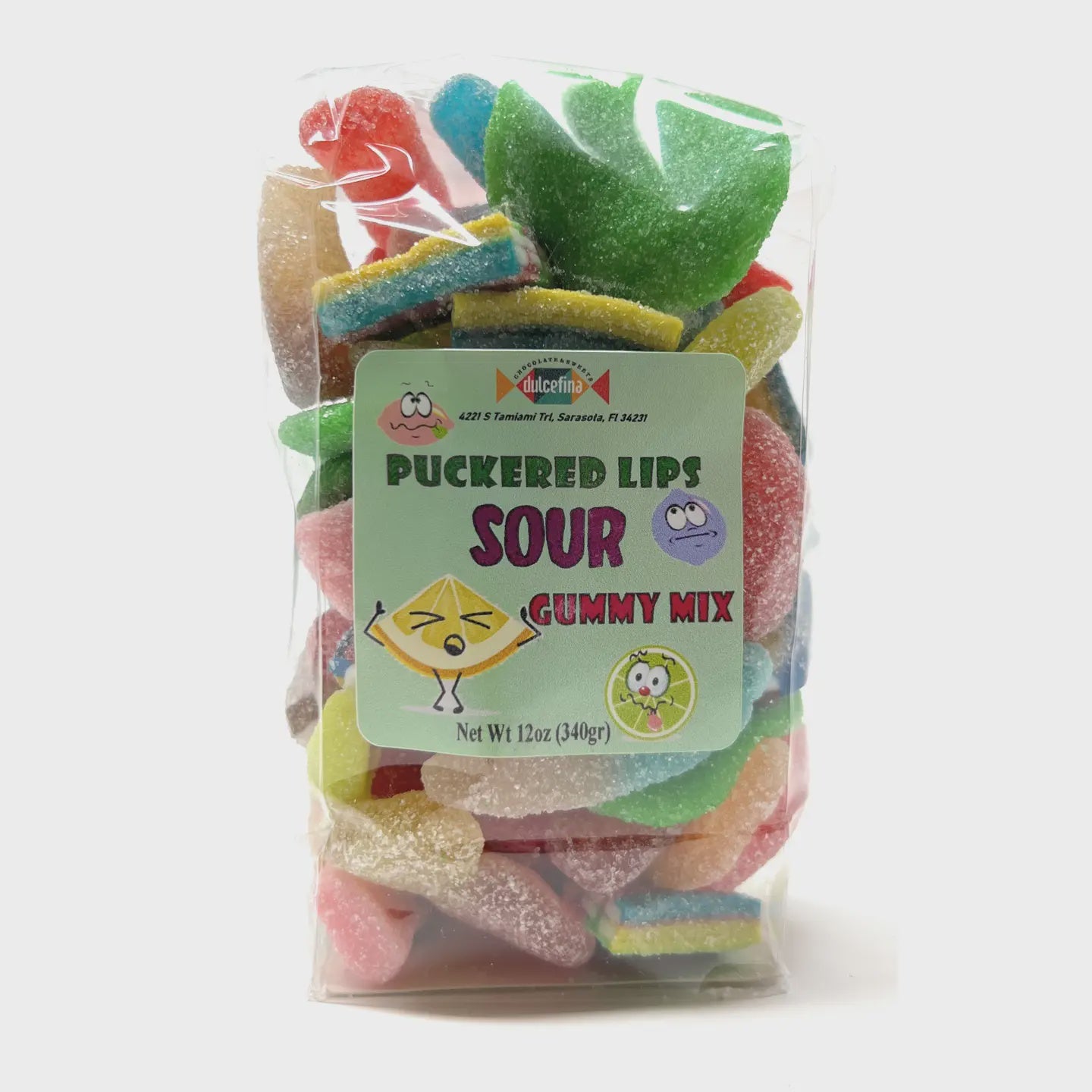 A clear bag of "DCS Sour Gummi Mix" from Faire displays vibrant, lip-shaped gummy candies in colors such as red, green, and blue. The playful label indicates a net weight of 12 oz (340 grams).