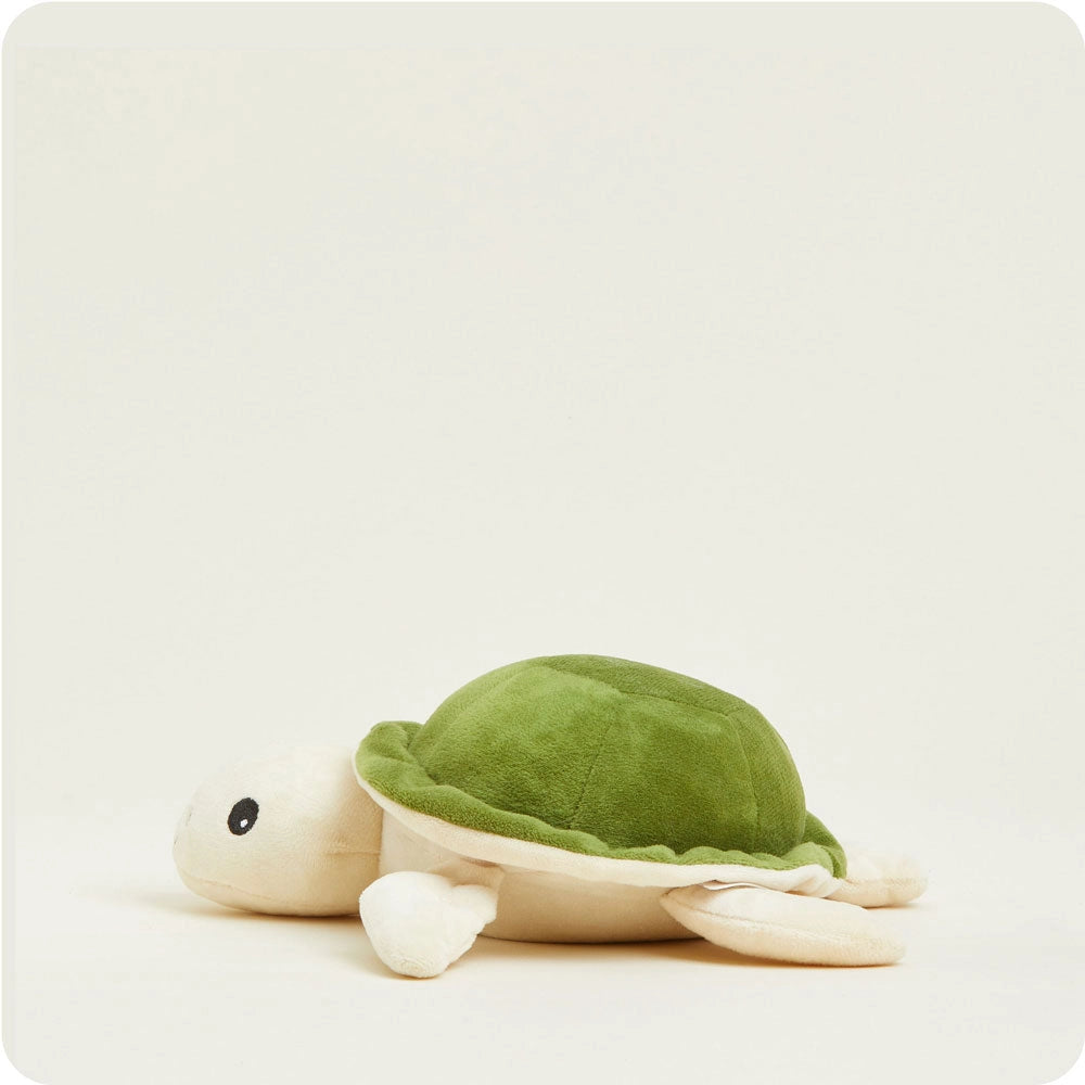 The Turtle Warmies Junior by Faire is a soft, microwavable plush with a green shell and beige body, featuring black round eyes and a cute design—perfect as a cozy sensory toy.