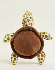 The Faire Turtle Warmies is a microwavable plush with a soft brown shell and yellow-and-white spotted details, providing soothing sensory comfort when placed upright against a light background.