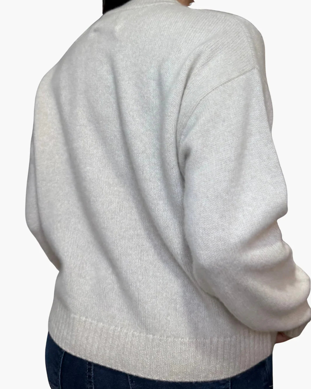 A person wearing the White + Warren Cashmere Argyle Crew in light gray with dark blue jeans, shown from the back against a plain white background.