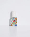 The Maison Matine Perfume by Faire features a clear glass bottle with a white cap, adorned with vibrant floral and leaf designs, standing upright against a plain white background, and evokes notes of vanilla and bergamot.
