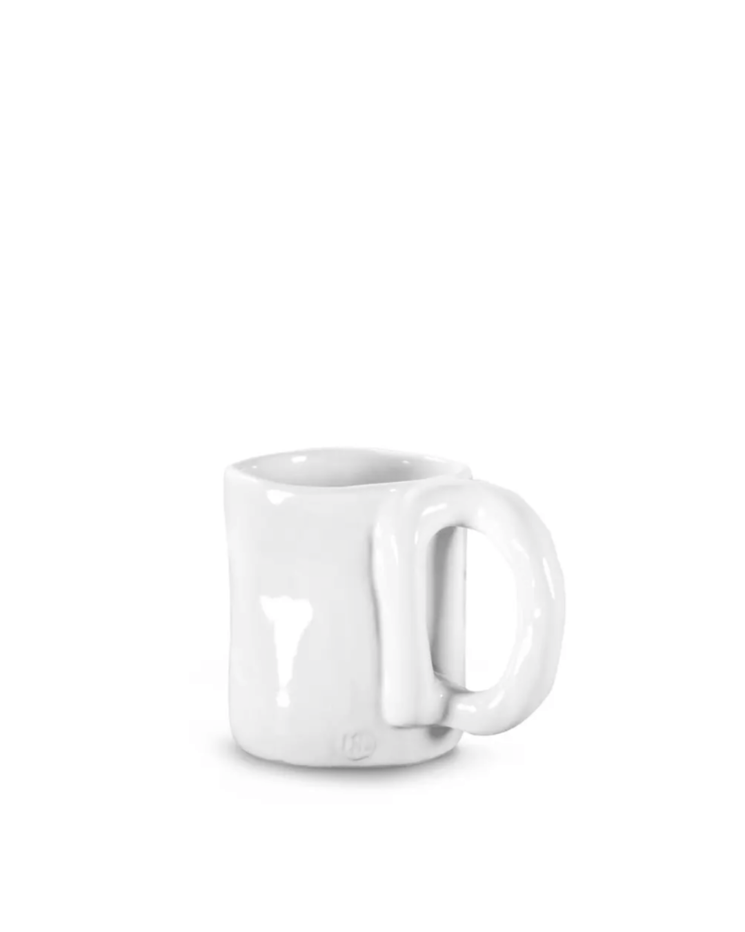 A white ceramic Mug No. 205 by Montes Doggett with an intentionally irregular shape, featuring a thick handle and a slightly uneven surface, is displayed against a plain white background. The handmade ceramic dinnerware design gives the mug a rustic appearance, highlighting its high-fired quality and crafting origins in Peru.