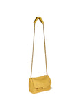 The Lulu Small Bag by Jerome Dreyfuss, a small yellow purse with a gold cross-body chain strap, hangs from a hook. This mini messenger bag features a flap closure and maintains a simple, elegant design.