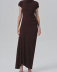 Kira sculptural dress by Citizens Of Humanity/AGOLDE in black, styled with heels against a simple background.