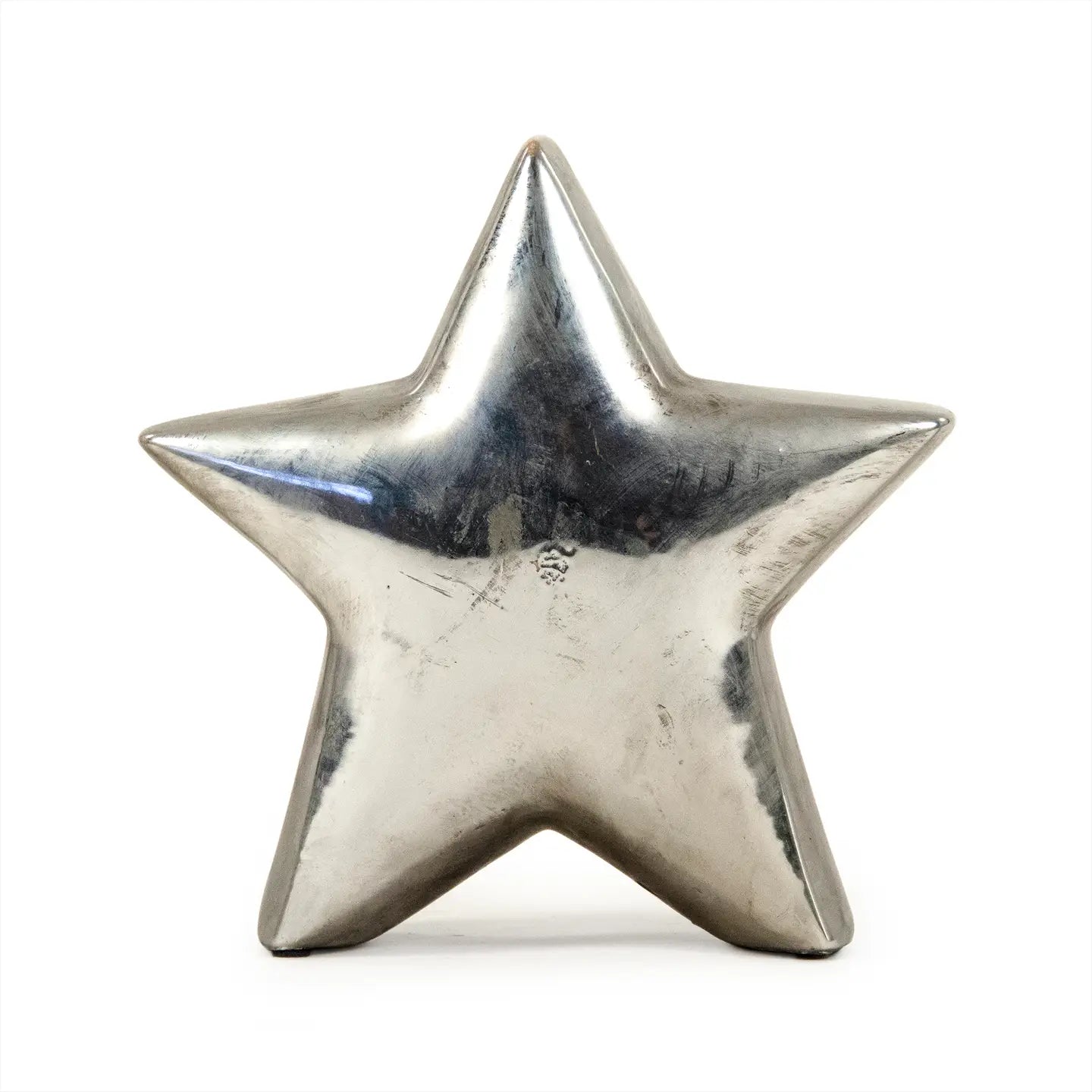 The Zentique Distressed Metallic Star is a five-pointed silver sculpture that stands upright, adding modern flair and striking style to your home decor.