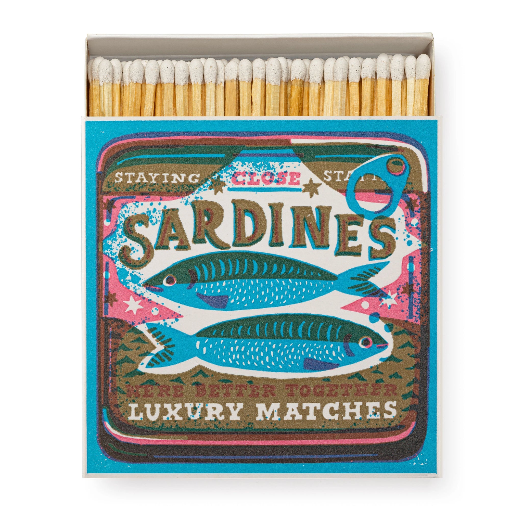 Faire’s Matches/Square features a matchbox designed by Saint No, with two illustrated sardines and bold “SARDINES” and “LUXURY MATCHES,” styled like a classic sardine tin.