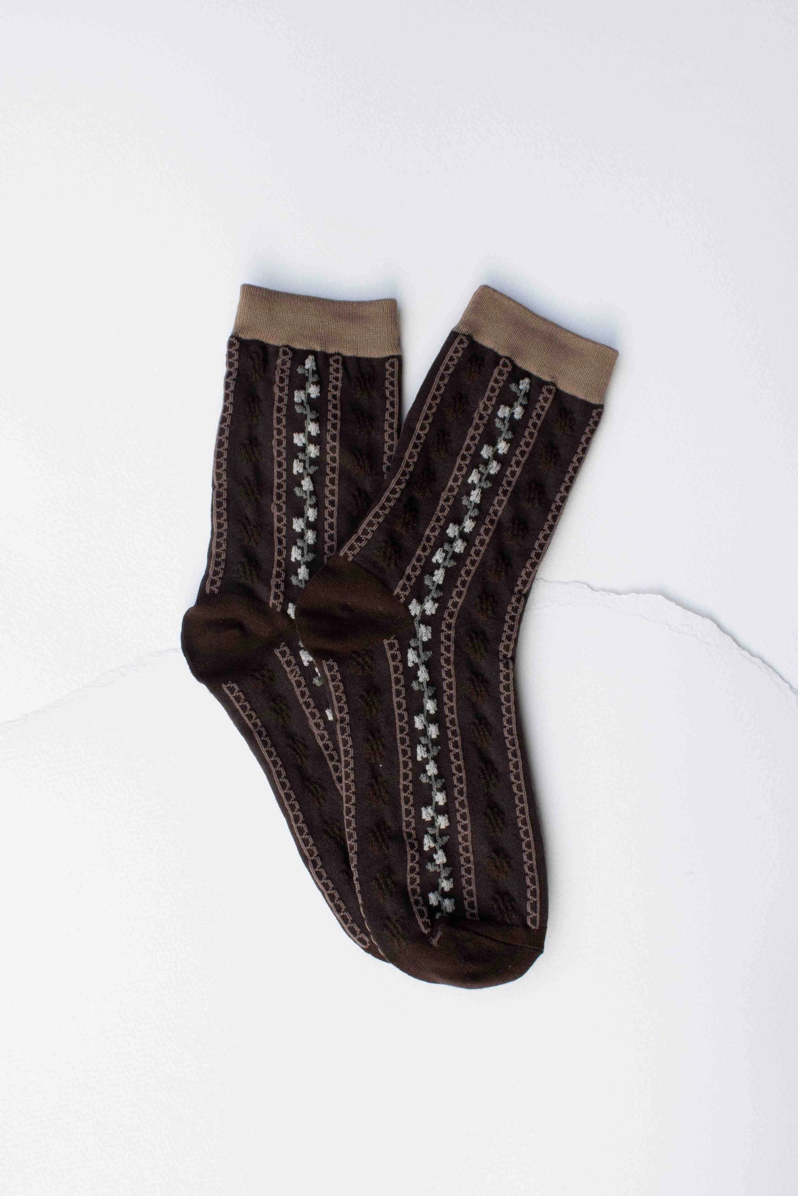 Faire Vintage Stripe Floral Socks in brown with tan cuffs feature light brown and white decorative vertical patterns, displayed flat on a white surface.