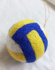 The Faire Felted Ornament features yellow, blue, and white felted sections and comes with an attached string—perfect for hanging as a Christmas ornament or adding to your collection of assorted felt ornaments.