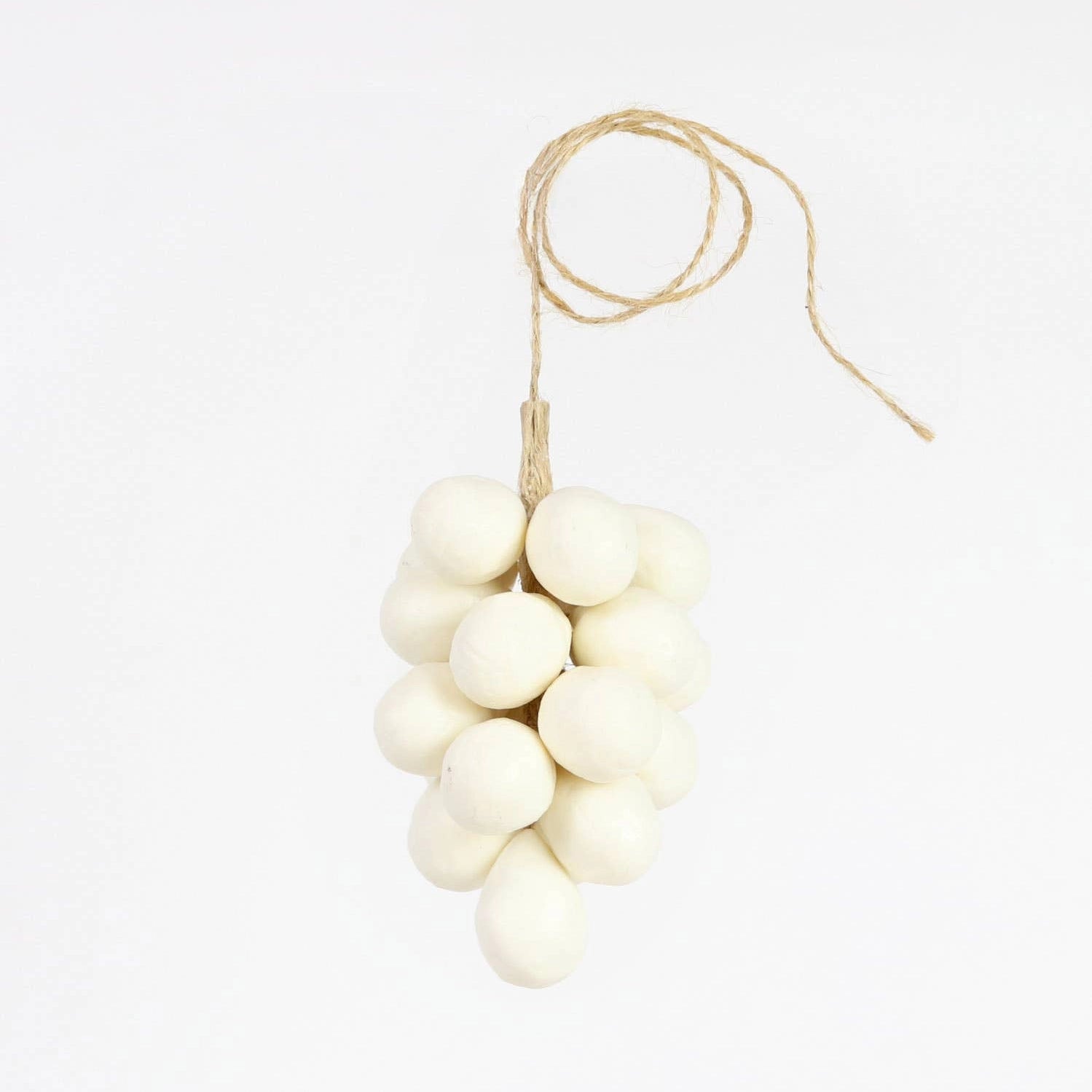 A cluster of white, grape-shaped soaps from Faire’s Handcrafted Grapes Soap collection is artfully arranged on twine and displayed against a plain white background.