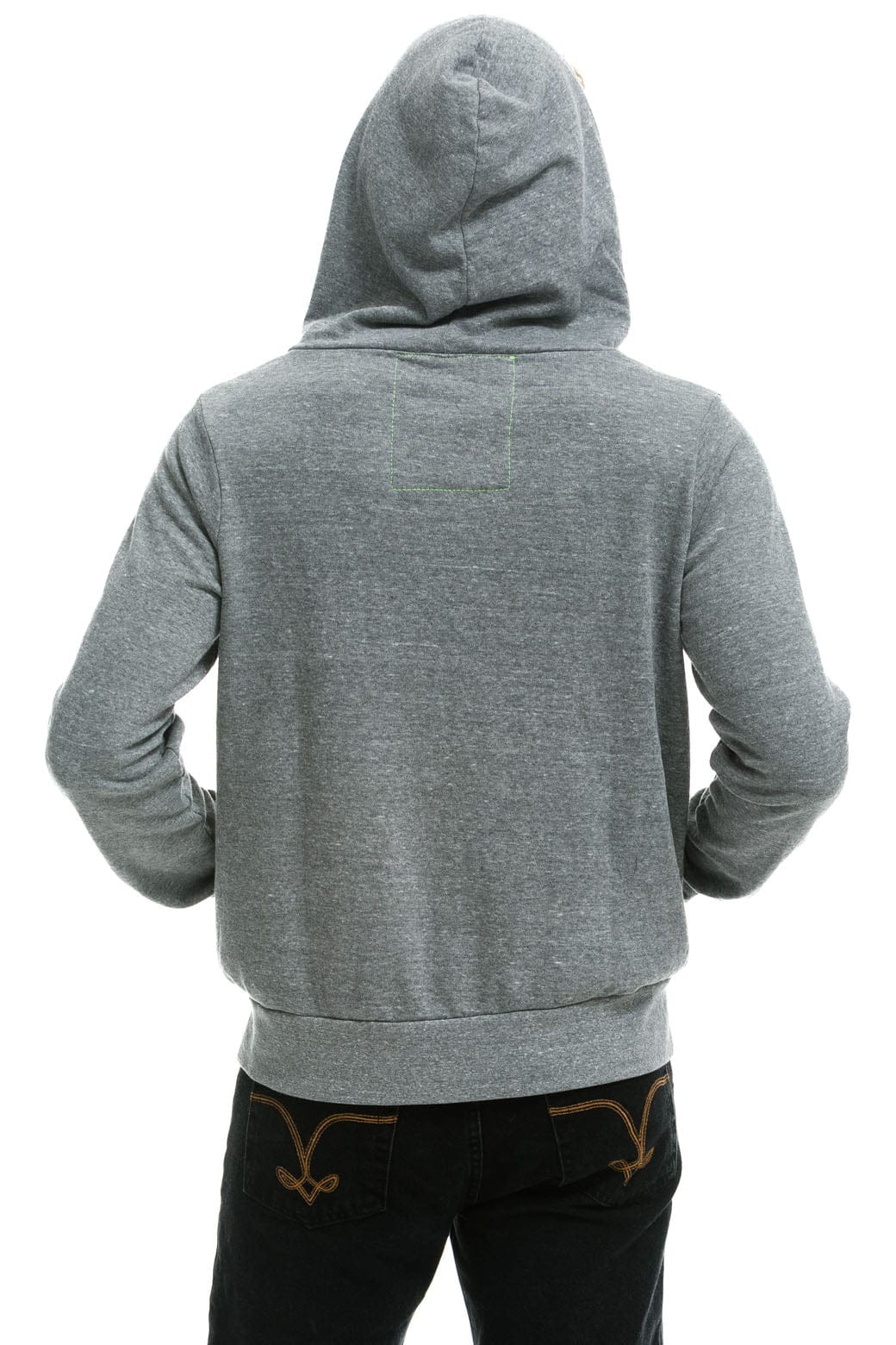 A person is shown from the back, standing with hands on hips against a white background, wearing the Aviator Nation 5 stripe - zip hoodie in gray and dark jeans.