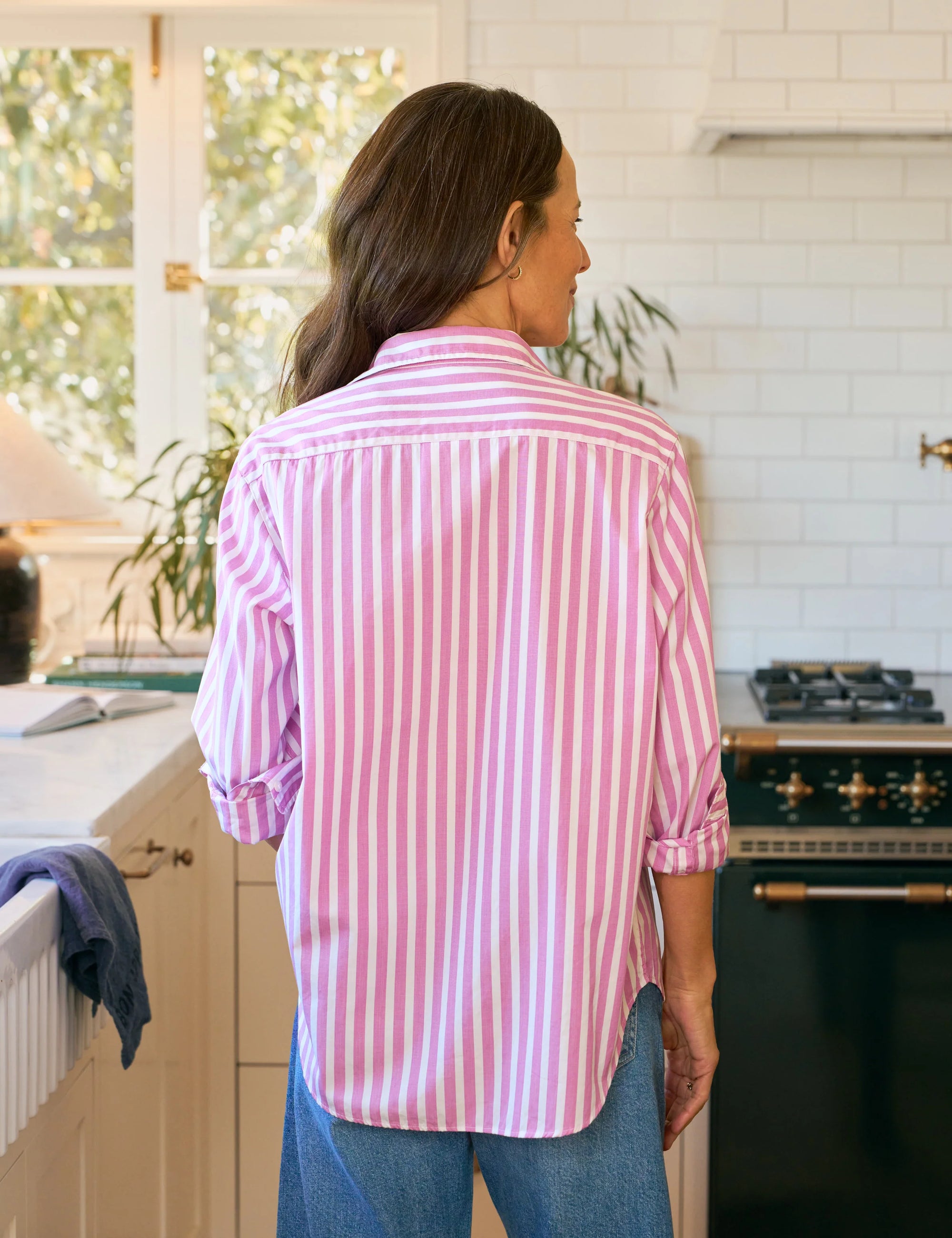 A woman in a Frank & Eileen BARRY Tailored pink and white striped button-up shirt.