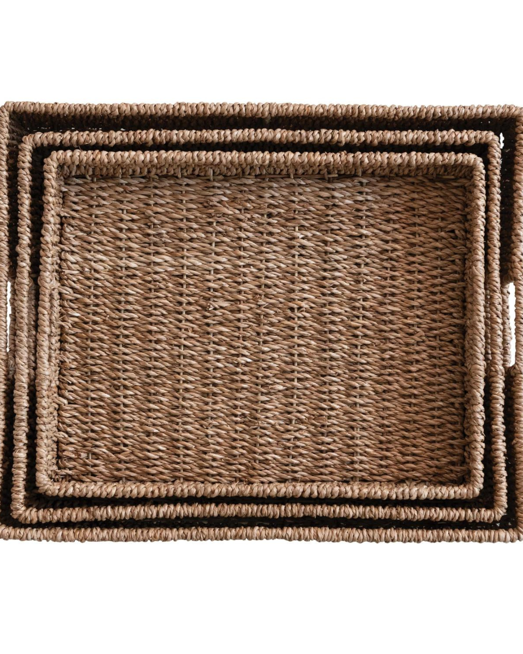 Creative Co-op's Hand-Woven Bankuan Trays come as a set of three nested rectangular trays in descending sizes. The trays, stacked one inside the other, feature slightly raised edges and side handles for easy carrying. Made from natural Bankuan material, they display a textured pattern that complements any farmhouse decor perfectly.