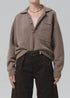 Agatha Rugby sweater by Citizens Of Humanity/AGOLDE in dark knit, paired with black pants and a gold chain necklace.