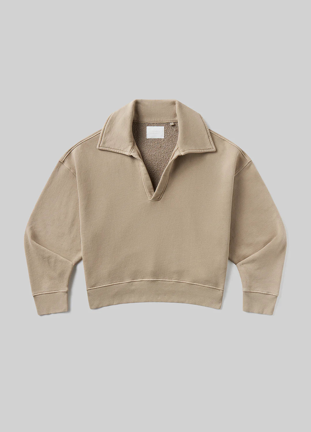 The trapeze pullover by Citizens Of Humanity/AGOLDE is a beige, long-sleeve sueded fleece with a wide open collar and relaxed fit, shown laid flat on a light gray background.