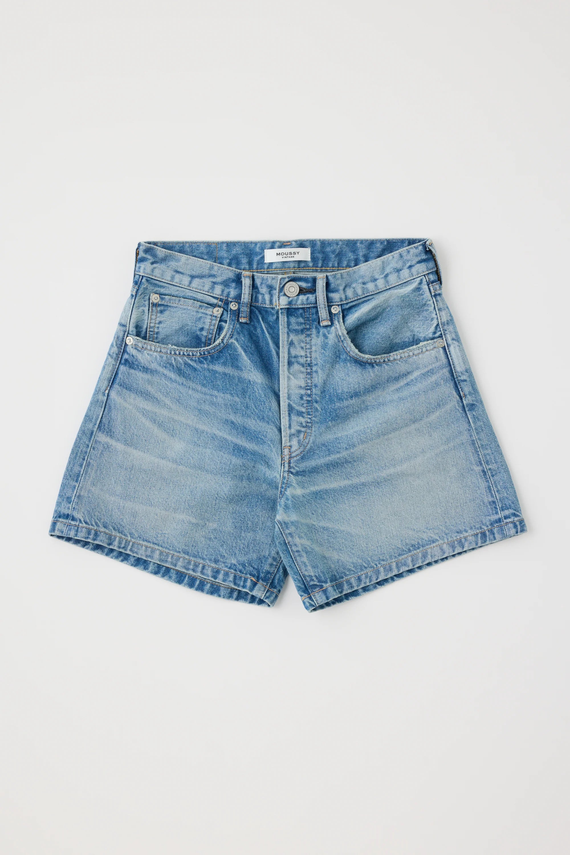 The Moussy Harrisburg Long Shorts, made from light stretch denim in light blue, feature a classic five-pocket design, belt loops, and a button fly. They are shown laid flat on a white background.