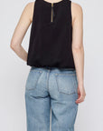 Sculpted Satin sleeveless top by Moussy with back zipper, shown with light blue jeans, rear view.