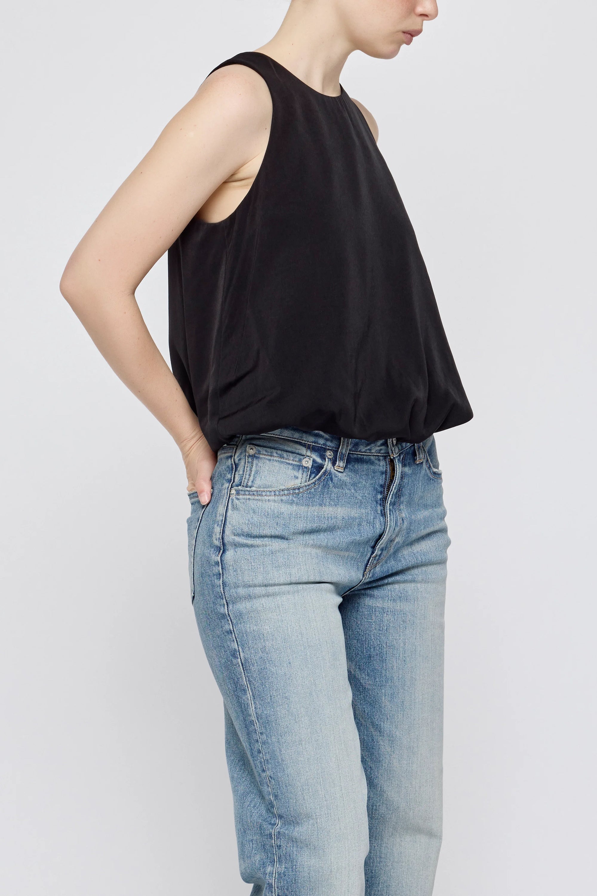 Moussy MV Sculpted Satin Top with scoop neckline styled with light blue jeans, hand in pocket.