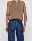 Brown sculpted satin sleeveless top by Moussy with back zipper, shown from behind, paired with blue jeans.