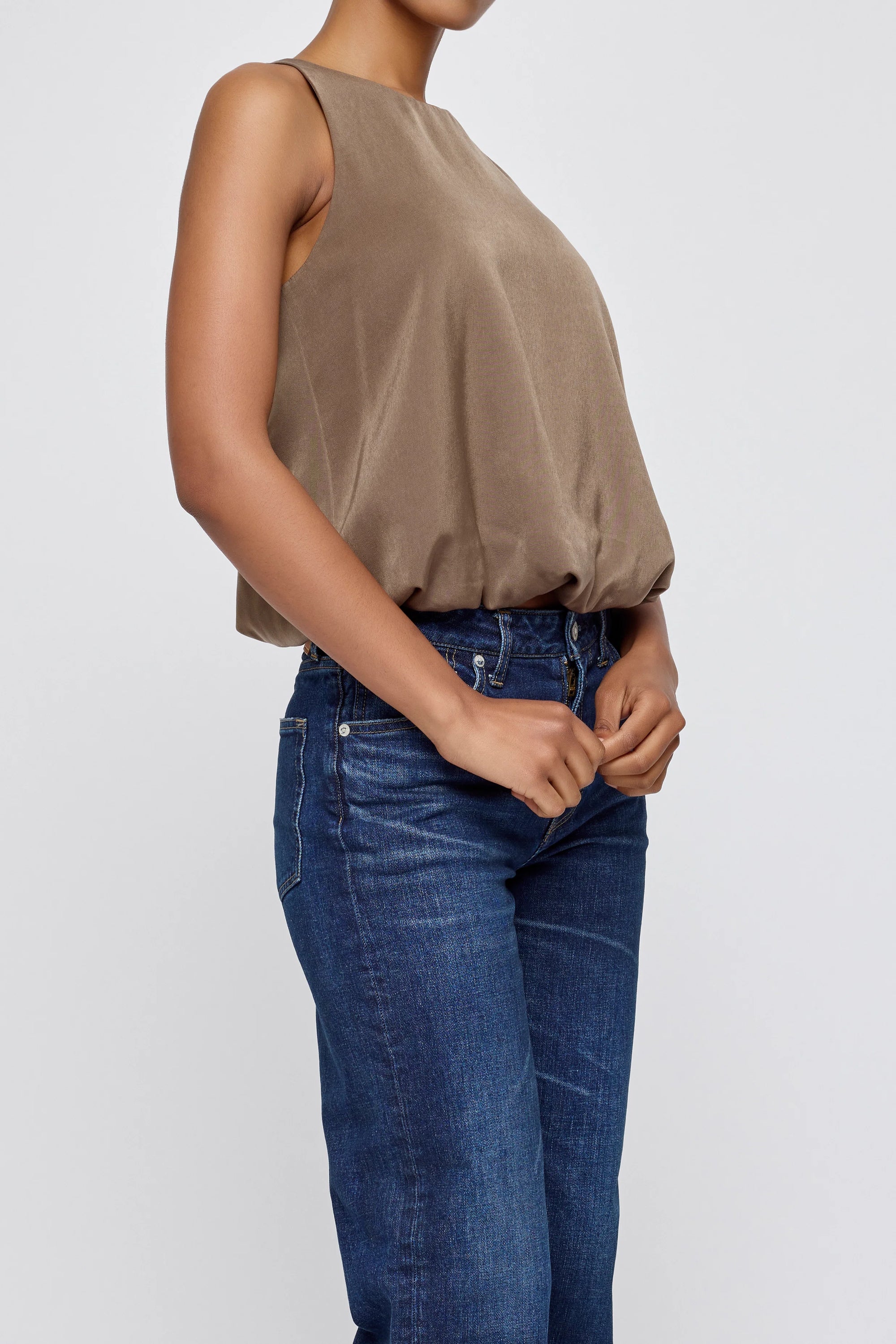 Moussy MV Sculpted Satin Top with scoop neckline styled with blue jeans, hands clasped in front.