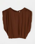 The MV Satin Shell Cap Top by Moussy is a sleeveless dark brown blouse with gathered shoulders and a round neckline. Its voluminous drape adds versatility, shown here flat on a white background.