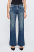 Only the lower torso and legs are visible as a person stands against a plain white background, wearing Moussy's Lismore 70's Flare high-waisted blue jeans paired with black pointed-toe shoes.