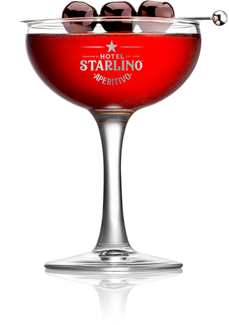 A glass of red aperitivo, featuring Italian Maraschino Cherries by Faire, embodies the sophistication of luxury cherry, with three cherries skewered on a stick as an elegant garnish.