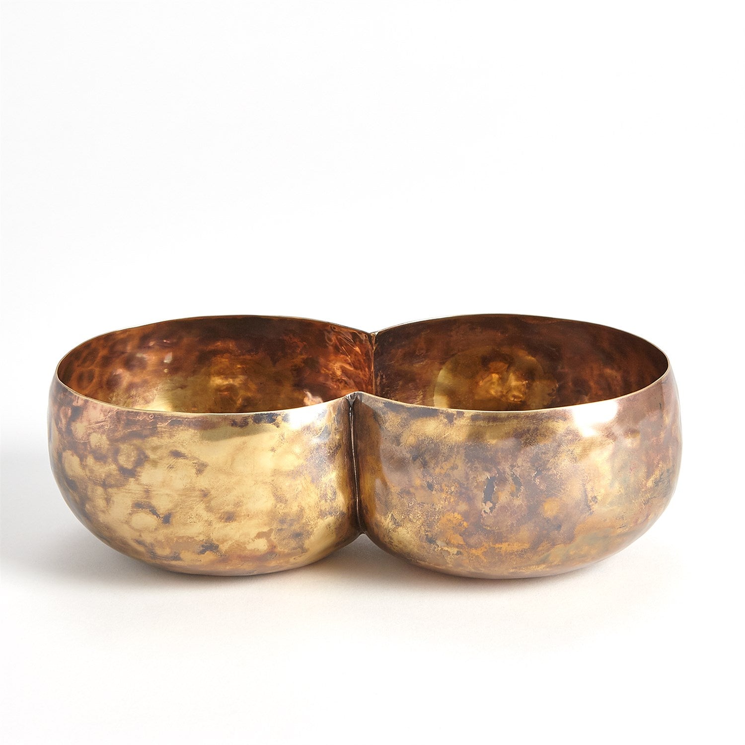 The Double Alchemy Container by Global Views is a handcrafted, double-chambered copper bowl with a rustic hammered texture and warm patina. Its symmetrical design against a light background adds charm reminiscent of elegantly oxidized brass.