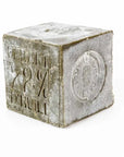 Marseille Olive Oil Soap by Cie Luxe Brands is a gray cube embossed with "GARANTI 72% D'HUILE" and a circular French stamp, showcasing its authentic use of rich botanical oils and rustic, traditional French craftsmanship.