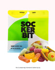 A vibrant green and white package labeled "Sockerbit Swedish Candy" from Faire offers a sour gummy mix made with non-GMO ingredients. Inside, discover gummies in diverse shapes and colors such as orange slices, green rings, and red tubes.