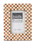 The 4x6 Bone/Wood Frame by BIDK Home features a beige and brown checkerboard pattern, ideal for home decor, and fits a 4"x6" photo. "BIDK Home" appears in gray and black text at the center.